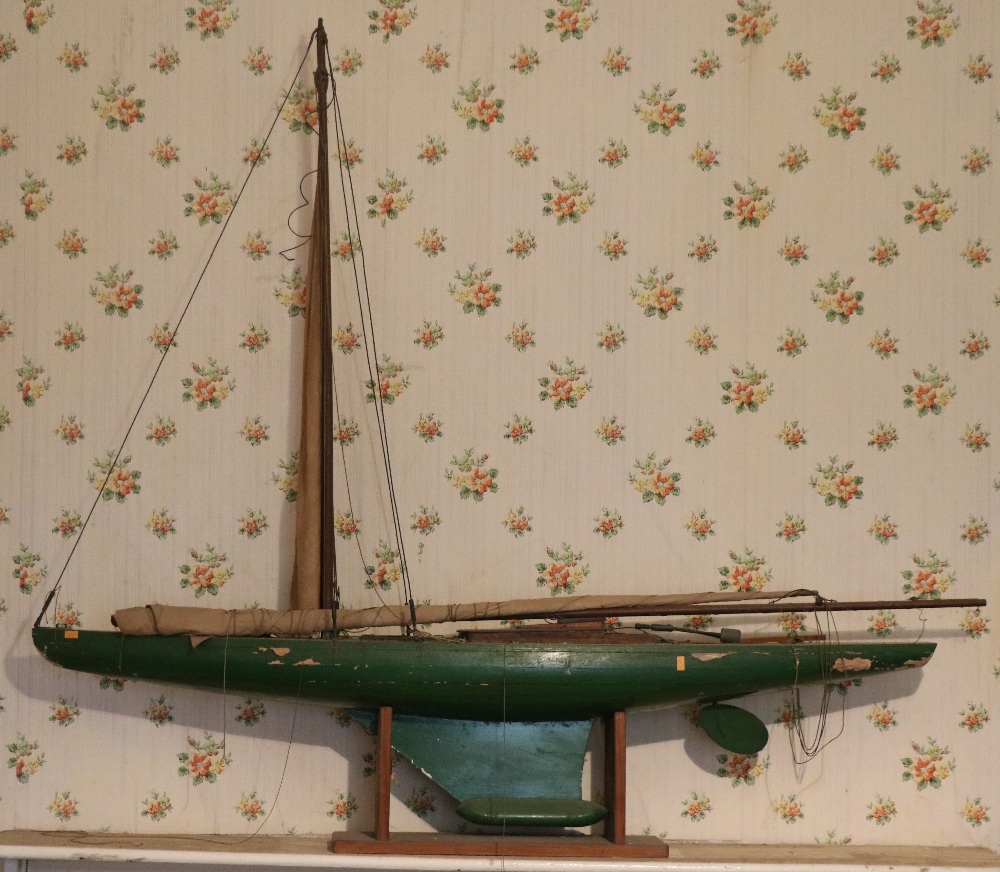 A large hand made Model of Yacht, with sails, 127cms (50") long, on wooden stand.