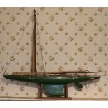 A large hand made Model of Yacht, with sails, 127cms (50") long, on wooden stand.