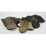 Two early leather Saddles, and a Child's Saddle (worn) with iron wall mount.