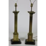 A pair of attractive tall Corinthian column brass Lamps, on stepped bases.