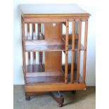 An Edwardian Revolving oak Bookcase, by Maple & Co., London, with enamel label, approx.