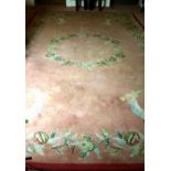 An attractive pink ground floral decorated Donegal woollen Carpet,