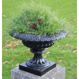 A set of four Victorian cast iron urn shaped Vases, with circular pillar supports, each approx.