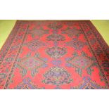 A good Turkish design crimson ground Rug, with large border and blue and green colouring, approx.