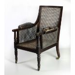 A Regency period mahogany Bergére Armchair, with cane work seat and side,