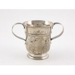 An embossed English silver Porringer type two handled Bowl,