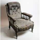 A carved Edwardian walnut Library Armchair, covered in hide.