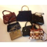 A collection of leather and assorted Hand Bags, together with some Vintage Clothing and fabrics.