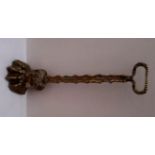 A 19th Century heavy brass Door Stop, modelled as a hairy paw foot with extended lift handle,