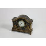 A chinoiserie decorated gilt and black lacquered Mantle Clock,