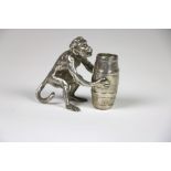 A silver mounted Vesta Stand, modelled with chimpanzee seated and holding a barrel, 2 3/4" (7cms),