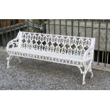 A pair of heavy Gothic style cast iron Garden Benches, with pierced backs on honeycomb type seats,