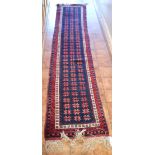 A very narrow dark blue ground Oriental Runner,