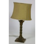 A brass Table Lamp, with Corinthian column pillar on step base with cream shade.