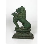 A Victorian cast iron Door Stop, modelled as a rampant lion on a plinth base, painted green, approx.