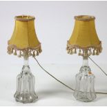 A pair of unusual glass Decanter Bottle Lamps, with yellow tasseled shades (converted.