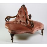 A Victorian walnut framed "Conversation" Centre Chair,