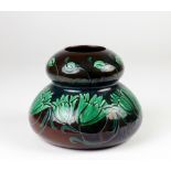 An attractive late 19th Century Art Pottery Faience bulbous Vase, decorated with green flower heads,