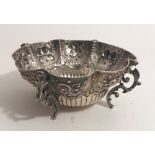 An attractive Victorian English circular silver Bowl, with eight panels decorated with fruit,