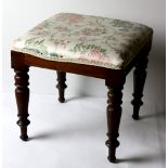 A 19th Century Irish mahogany framed Footstool, with floral padded seat on turned legs.