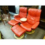 2 RED LEATHER RECLINING ARM CHAIRS AND FOOT STOOLS