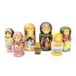 Seven sets of nesting Russian dolls, two sets with storyboard pictures to the fronts, all sets