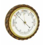 Oak aneroid barometer, the 10" dial within a carved rope twist surround