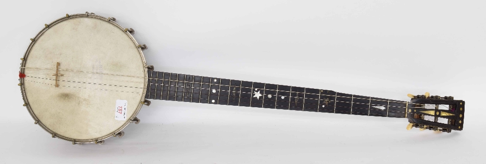 Interesting five string banjo branded Grade 5 behind the open peg box, with closed floral pressed