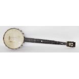 Interesting five string banjo branded Grade 5 behind the open peg box, with closed floral pressed