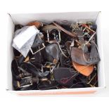 Box of violin accessories, including chin rests, bridges and tailpieces etc