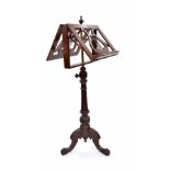 Good mahogany duet music stand, the lyre back ledges upon a turned column and carved tripod base