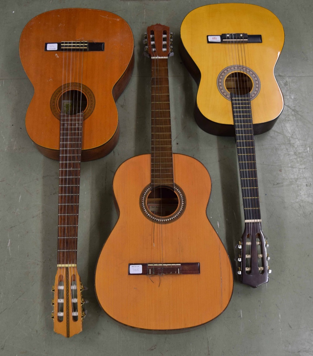 Three classical guitars in need of attention, comprising a Suzuki no. 166, a Vincente Sanchis and