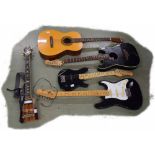 Five various guitars in need of attention, including a Fender Stratacoustic, an Eko Acoustic, a