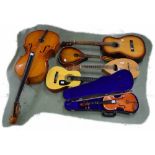 Six stringed musical instruments needing attention, comprising a Gremlin GR3220 mandola, a Terada