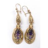 Pair of attractive yellow gold drop earrings, the drops of oval form each set with two amethysts,
