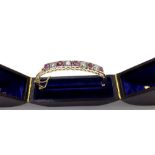 Attractive yellow gold ruby and diamond hinged bangle, set with five round-cut rubies interspersed
