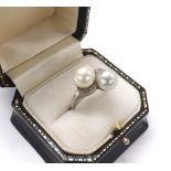 White gold cultured pearl and diamond crossover design ring, with two pearls each 8mm approx, set