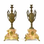 Pair of French spelter urns upon stepped pink marble bases, with gilt metal mounts and feet, 20"