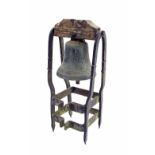 Cast bronze bell hung within an iron frame, with clanger, 24'' high, the bell 7.5'' high x 8''