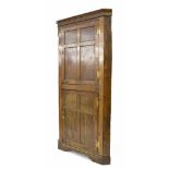 George III oak panelled standing corner cupboard, with two doors opening to reveal shelved