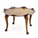 Hardwood circular top table with wavy rim, upon four curved legs terminating in pad feet, 29'' wide,