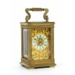 Miniature French carriage clock timepiece, the 1.25" cream chapter ring within a pierced foliate