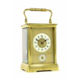 French alarm carriage clock striking on a gong, the 2" cream chapter ring enclosing a gilt turned