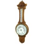 Oak banjo barometer/thermometer, the 8" cream dial within a foliate carved case