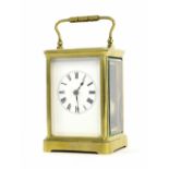 French carriage clock striking on a gong, within a corniche brass case, 7.25" high (key)