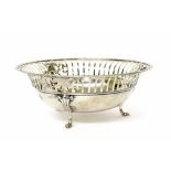 George V circular silver basket with a pierced rim upon three scroll feet, maker James Dixon &