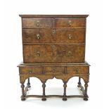 Early 18th century and later walnut low chest on stand, the moulded top over two short and two