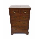 19th century mahogany chest of drawers of small proportion, the top drawer with a dummy short drawer