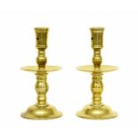 Pair of brass Heemskirk brass candlesticks, with turned stems and central drip pans upon domed