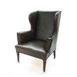 Good late 19th century wing armchair in the Georgian manner, with green leather upholstery upon